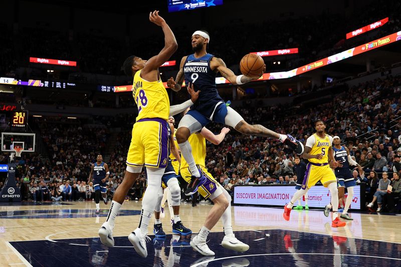 MINNEAPOLIS, MINNESOTA - DECEMBER 13: Nickeil Alexander-Walker #9 of the Minnesota Timberwolves passes the ball against Rui Hachimura #28 of the Los Angeles Lakers in the first quarter at Target Center on December 13, 2024 in Minneapolis, Minnesota. NOTE TO USER: User expressly acknowledges and agrees that, by downloading and or using this photograph, User is consenting to the terms and conditions of the Getty Images License Agreement. (Photo by David Berding/Getty Images)