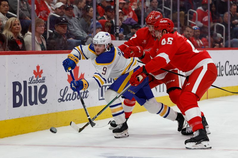 Apr 7, 2024; Detroit, Michigan, USA; Buffalo Sabres left wing Zach Benson (9) skates with the puck defended by defenseman Simon Edvinsson (77) and Detroit Red Wings defenseman Jeff Petry (46) in the third period at Little Caesars Arena. Mandatory Credit: Rick Osentoski-USA TODAY Sports