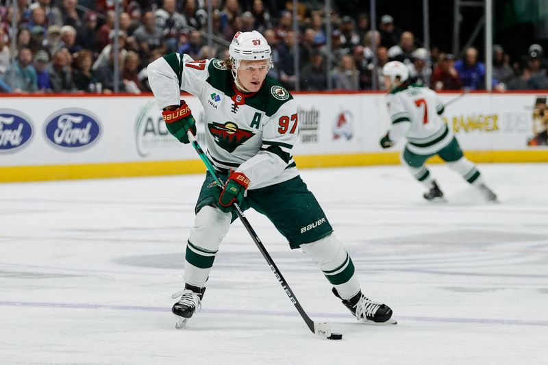Apr 9, 2024; Denver, Colorado, USA; Minnesota Wild left wing Kirill Kaprizov (97) controls the puck in the first period against the Colorado Avalanche at Ball Arena. Mandatory Credit: Isaiah J. Downing-USA TODAY Sports