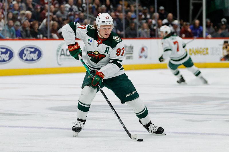 Apr 9, 2024; Denver, Colorado, USA; Minnesota Wild left wing Kirill Kaprizov (97) controls the puck in the first period against the Colorado Avalanche at Ball Arena. Mandatory Credit: Isaiah J. Downing-USA TODAY Sports