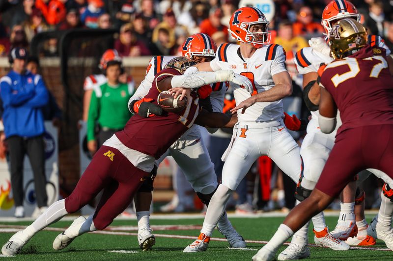 Nov 4, 2023; Minneapolis, Minnesota, USA; Minnesota Golden Gophers defensive lineman Jah Joyner (17) forces a fumble on Illinois Fighting Illini quarterback Luke Altmyer (9) during the second half at Huntington Bank Stadium. Mandatory Credit: Matt Krohn-USA TODAY Sports