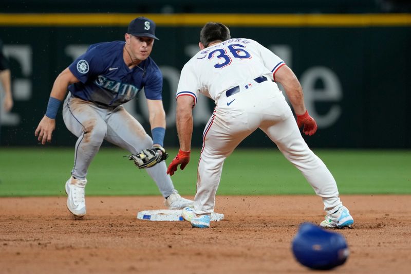 Apr 24, 2024; Arlington, Texas, USA; Texas Rangers designated hitter Wyatt Langford (36) is tagged out by Seattle Mariners shortstop J.P. Crawford (3) at second after falling while rounding second base on his double during the second inning at Globe Life Field. Mandatory Credit: Jim Cowsert-USA TODAY Sports