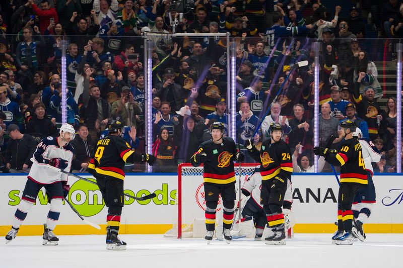 Jan 27, 2024; Vancouver, British Columbia, CAN; Columbus Blue Jackets defenseman Erik Gudbranson (44) and goalie Elvis Merzlikins (90) and forward Alexandre Texier (42) watch as Vancouver Canucks forward J.T. Miller (9) and forward Brock Boeser (6) and forward Pius Suter (24) and forward Elias Pettersson (40) celebrate Boeser s second goal of the game in the third period at Rogers Arena. Canucks won 5-4 in overtime. Mandatory Credit: Bob Frid-USA TODAY Sports