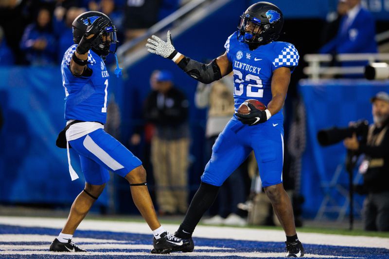 Nov 26, 2022; Lexington, Kentucky, USA; Kentucky Wildcats linebacker Trevin Wallace (32) celebrates with defensive back Zion Childress (11) after an interception against the Louisville Cardinals during the third quarter at Kroger Field. Mandatory Credit: Jordan Prather-USA TODAY Sports