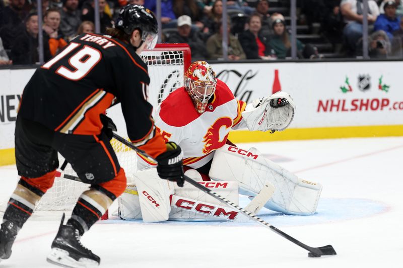 Dec 21, 2023; Anaheim, California, USA;  Calgary Flames goaltender Jacob Markstrom (25) defends the goal against Anaheim Ducks right wing Troy Terry (19) during the second period at Honda Center. Mandatory Credit: Kiyoshi Mio-USA TODAY Sports