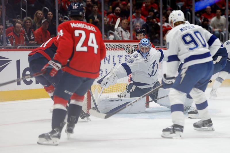 Mar 1, 2025; Washington, District of Columbia, USA; Tampa Bay Lightning goaltender Andrei Vasilevskiy (88) makes a save on Washington Capitals left wing Pierre-Luc Dubois (80) in the first period at Capital One Arena. Mandatory Credit: Geoff Burke-Imagn Images