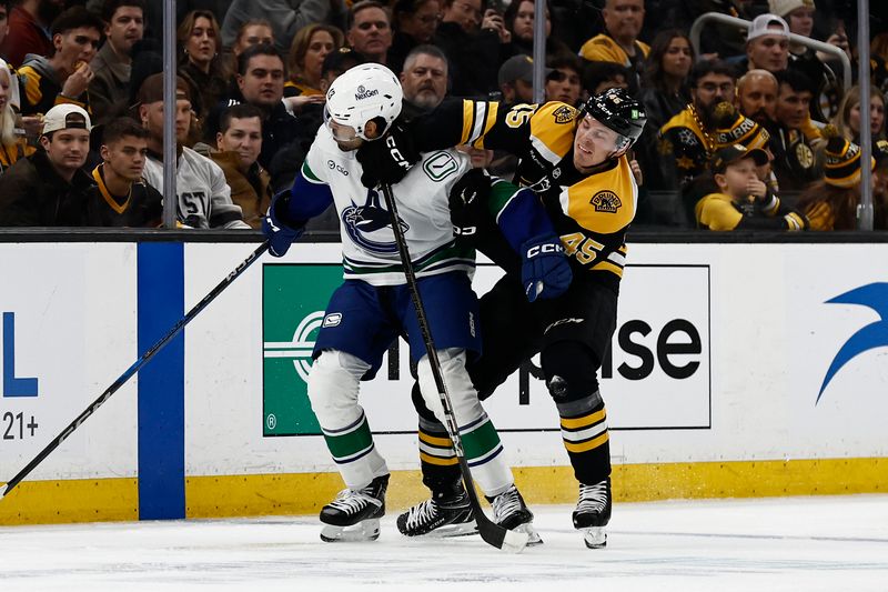 Nov 26, 2024; Boston, Massachusetts, USA; Boston Bruins left wing Cole Koepke (45) gets tangled up with Vancouver Canucks left wing Arshdeep Bains (13) during the first period at TD Garden. Mandatory Credit: Winslow Townson-Imagn Images