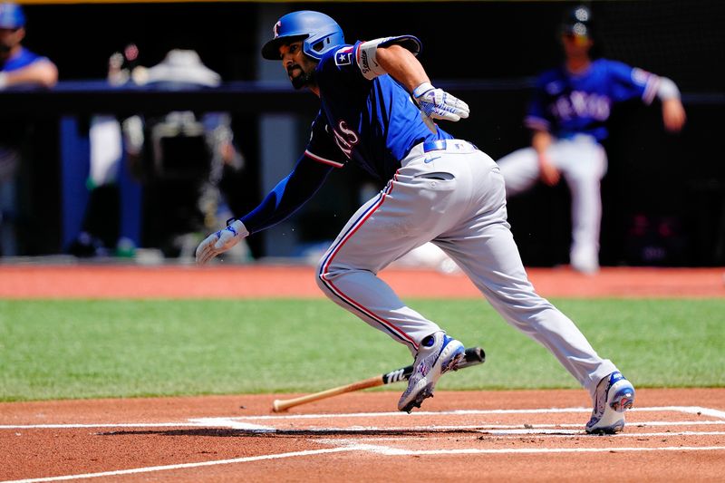 Jul 28, 2024; Toronto, Ontario, CAN; Texas Rangers second baseman Marcus Semien (2) heads to first base and is safe on a throwing error by Toronto Blue Jays third baseman Ernie Clement (not pictured) during the first inning at Rogers Centre. Mandatory Credit: John E. Sokolowski-USA TODAY Sports