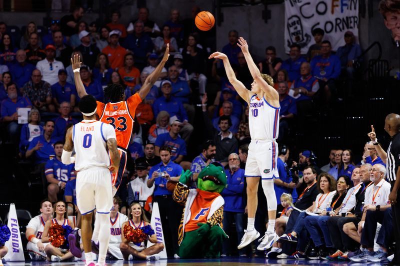 Jan 24, 2026; Gainesville, Florida, USA; Florida Gators forward Thomas Haugh (10) makes a three point basket over Auburn Tigers forward Sebastian Williams-Adams (33) during the first half at Exactech Arena at the Stephen C. O'Connell Center. Mandatory Credit: Matt Pendleton-Imagn Images