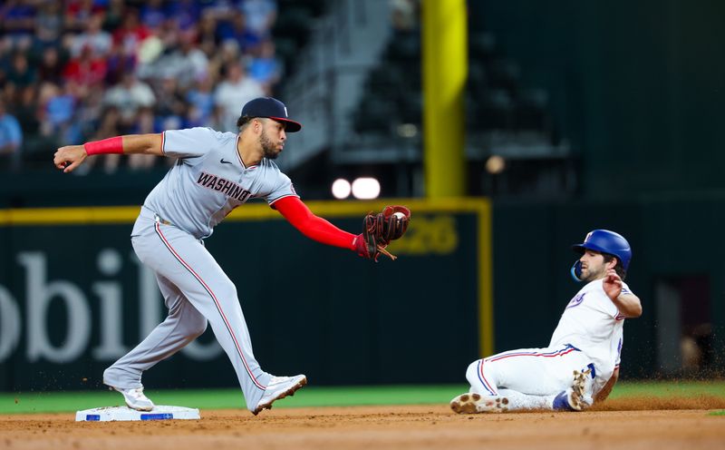 Apr 30, 2024; Arlington, Texas, USA;  Washington Nationals second base Luis García Jr. (2) forces out Texas Rangers third base Josh Smith (8) during the second inning at Globe Life Field. Mandatory Credit: Kevin Jairaj-USA TODAY Sports