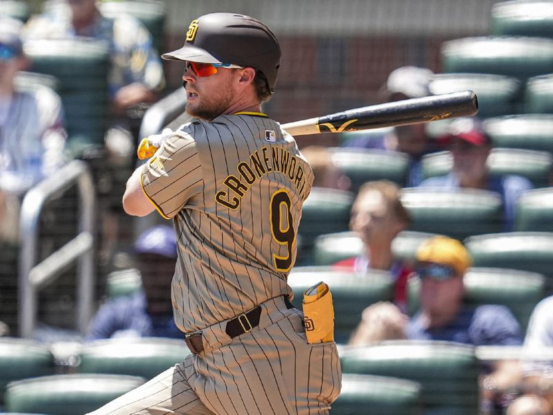 May 20, 2024; Cumberland, Georgia, USA; San Diego Padres first baseman Jake Cronenworth (9) singles to drive in two runs against the Atlanta Braves during the eighth inning at Truist Park. Mandatory Credit: Dale Zanine-USA TODAY Sports