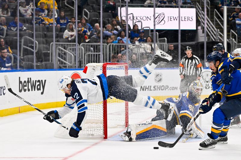 Nov 7, 2023; St. Louis, Missouri, USA;  Winnipeg Jets center Mason Appleton (22) trips over the pad of St. Louis Blues goaltender Jordan Binnington (50) as he makes a save during the third period at Enterprise Center. Mandatory Credit: Jeff Curry-USA TODAY Sports