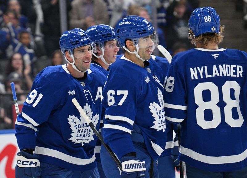 Sep 26, 2024; Toronto, Ontario, CAN;  Toronto Maple Leafs forward John Tavares (91) celebrates with team mates after scoring against the Montreal Canadiens in the first period at Scotiabank Arena. Mandatory Credit: Dan Hamilton-Imagn Images