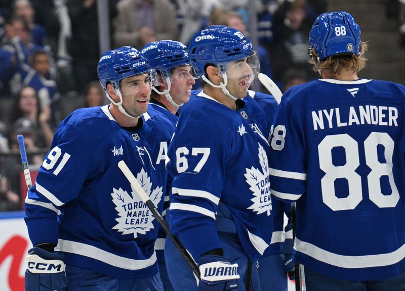 Sep 26, 2024; Toronto, Ontario, CAN;  Toronto Maple Leafs forward John Tavares (91) celebrates with team mates after scoring against the Montreal Canadiens in the first period at Scotiabank Arena. Mandatory Credit: Dan Hamilton-Imagn Images