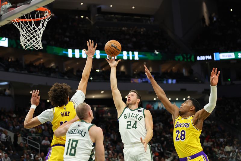 MILWAUKEE, WISCONSIN - OCTOBER 10: Pat Connaughton #24 of the Milwaukee Bucks shoots over Jaxson Hayes #11 of the Los Angeles Lakers during the second half of a preseason game at Fiserv Forum on October 10, 2024 in Milwaukee, Wisconsin.  NOTE TO USER: User expressly acknowledges and agrees that, by downloading and or using this photograph, User is consenting to the terms and conditions of the Getty Images License Agreement. (Photo by Stacy Revere/Getty Images)