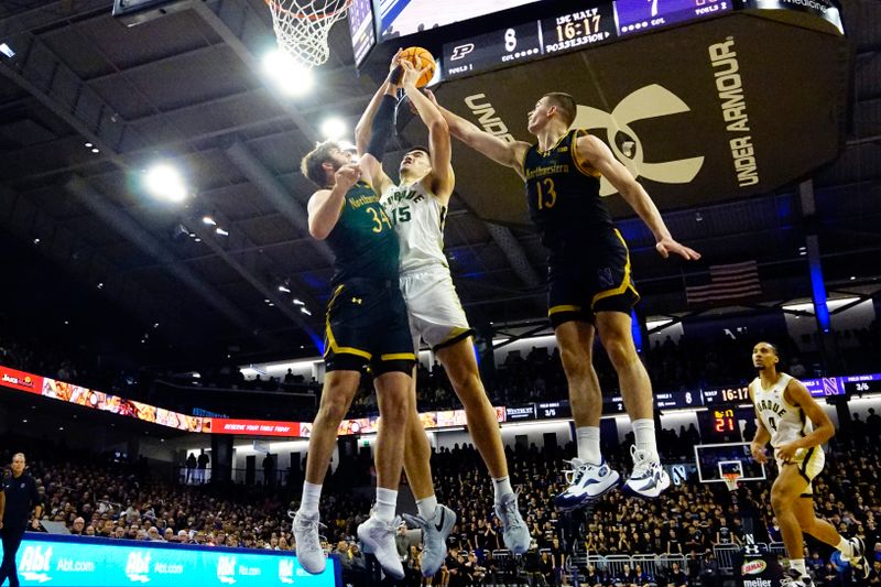 Dec 1, 2023; Evanston, Illinois, USA; Northwestern Wildcats center Matthew Nicholson (34) defends Purdue Boilermakers center Zach Edey (15) during the first half at Welsh-Ryan Arena. Mandatory Credit: David Banks-USA TODAY Sports