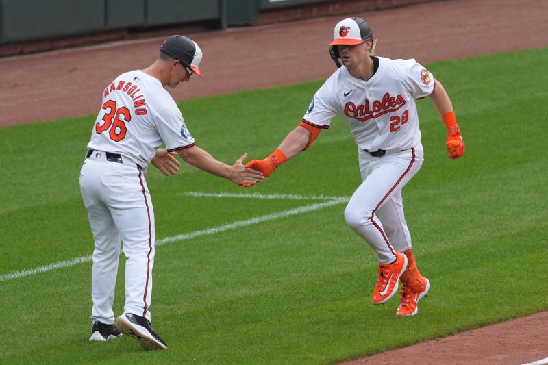 Jun 13, 2024; Baltimore, Maryland, USA; Baltimore Orioles outfielder Kyle Stowers (28) greeted by coach Tony Mansolino (36) after his three run home run in the seventh inning against the Atlanta Braves at Oriole Park at Camden Yards. Mandatory Credit: Mitch Stringer-USA TODAY Sports