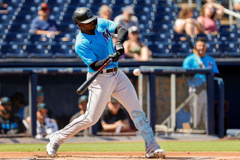 Mar 2, 2023; West Palm Beach, Florida, USA; Miami Marlins left fielder Jorge Soler (12) connects a base hit during the first inning against the Washington Nationals at The Ballpark of the Palm Beaches. Mandatory Credit: Sam Navarro-USA TODAY Sports