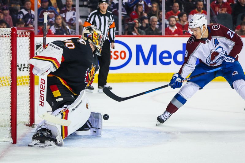 Mar 12, 2024; Calgary, Alberta, CAN; Calgary Flames goaltender Dan Vladar (80) makes a save against Colorado Avalanche center Nathan MacKinnon (29) during the first period at Scotiabank Saddledome. Mandatory Credit: Sergei Belski-USA TODAY Sports