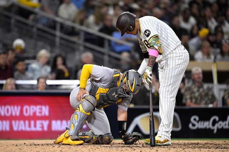 Jun 10, 2024; San Diego, California, USA; San Diego Padres designated hitter Manny Machado (right) checks on Oakland Athletics catcher Shea Langeliers (23) after being hit by a foul ball during the fifth inning at Petco Park. Mandatory Credit: Orlando Ramirez-USA TODAY Sports