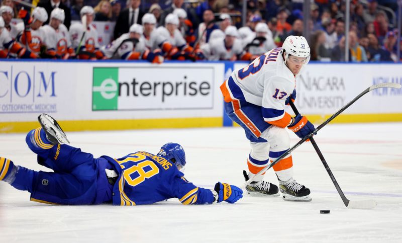 Mar 14, 2024; Buffalo, New York, USA;  Buffalo Sabres left wing Zemgus Girgensons (28) dives to try and knock the puck off the stick of New York Islanders center Mathew Barzal (13) during the first period at KeyBank Center. Mandatory Credit: Timothy T. Ludwig-USA TODAY Sports