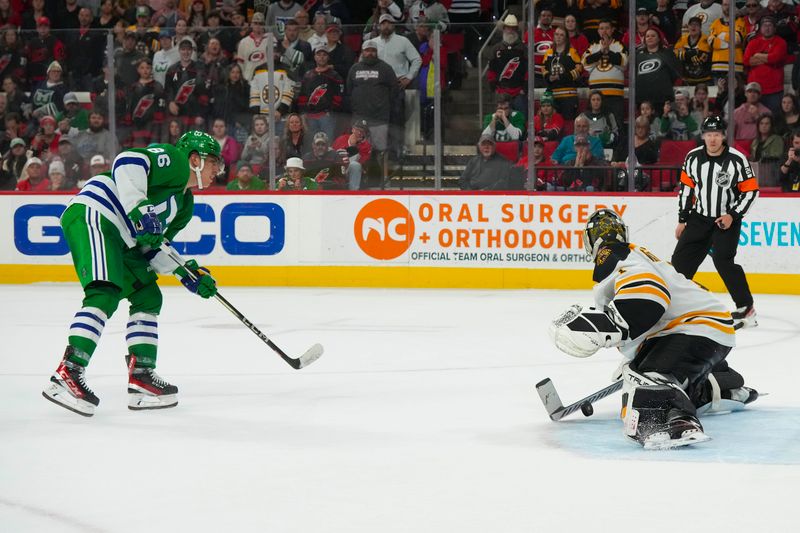 Mar 26, 2023; Raleigh, North Carolina, USA;  Boston Bruins goaltender Jeremy Swayman (1) stops the over time shot by Carolina Hurricanes left wing Teuvo Teravainen (86) at PNC Arena. Mandatory Credit: James Guillory-USA TODAY Sports