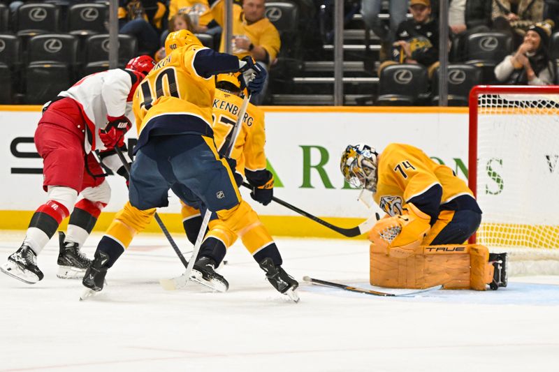 Dec 17, 2025; Nashville, Tennessee, USA;  Nashville Predators goaltender Juuse Saros (74) blocks the shot of Carolina Hurricanes right wing Jackson Blake (53) during the second period at Bridgestone Arena. Mandatory Credit: Steve Roberts-Imagn Images