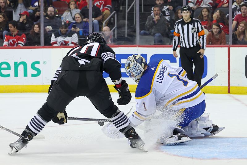 Oct 27, 2023; Newark, New Jersey, USA; Buffalo Sabres goaltender Ukko-Pekka Luukkonen (1) reaches for the puck in front of New Jersey Devils center Michael McLeod (20) during the third period at Prudential Center. Mandatory Credit: Vincent Carchietta-USA TODAY Sports