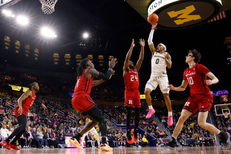 Feb 3, 2024; Ann Arbor, Michigan, USA;  Michigan Wolverines guard Dug McDaniel (0) shoots on Rutgers Scarlet Knights guard Austin Williams (24) in the first half at Crisler Center. Mandatory Credit: Rick Osentoski-USA TODAY Sports