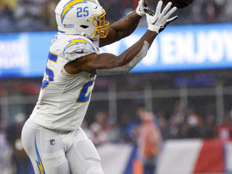 Los Angeles Chargers running back Joshua Kelley (25) attempts a reception during the second half of an NFL football game against the New England Patriots on Sunday, Dec. 3, 2023, in Foxborough, Mass. (AP Photo/Greg M. Cooper)