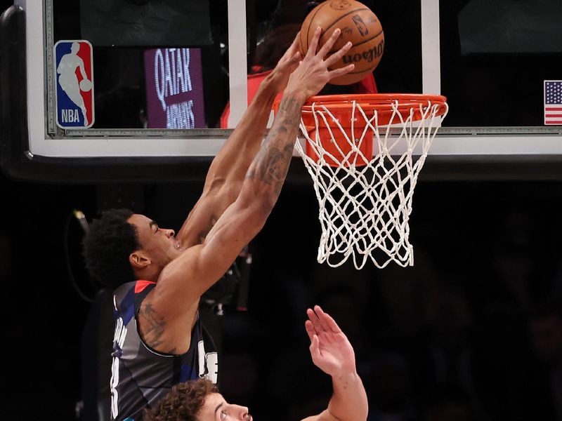 NEW YORK, NEW YORK - JANUARY 27:  Nic Claxton #33 of the Brooklyn Nets dunks against Alperen Sengun #28 of the Houston Rockets during their game at Barclays Center on January 27, 2024 in New York City.  User expressly acknowledges and agrees that, by downloading and or using this photograph, User is consenting to the terms and conditions of the Getty Images License Agreement.   (Photo by Al Bello/Getty Images)