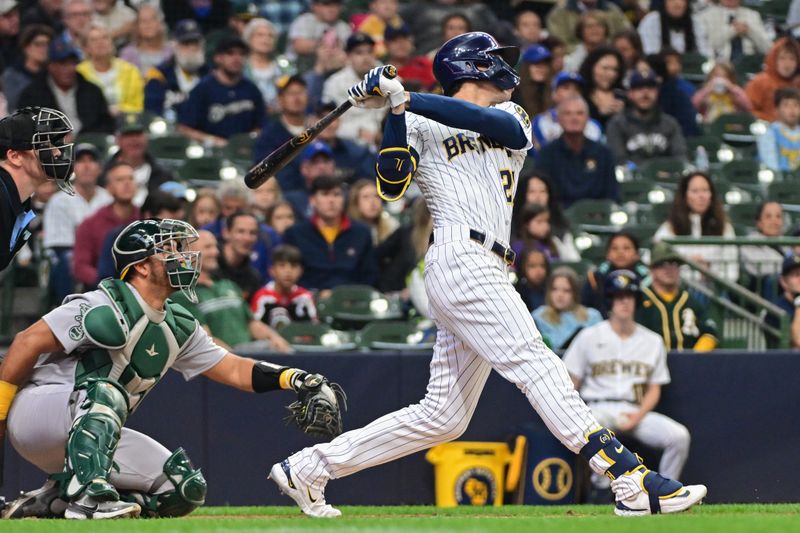 Jun 11, 2023; Milwaukee, Wisconsin, USA; Milwaukee Brewers designated hitter Christian Yelich (22) hits a solo home run as Oakland Athletes catcher Carlos Perez (44) looks on in the second inning at American Family Field. Mandatory Credit: Benny Sieu-USA TODAY Sports