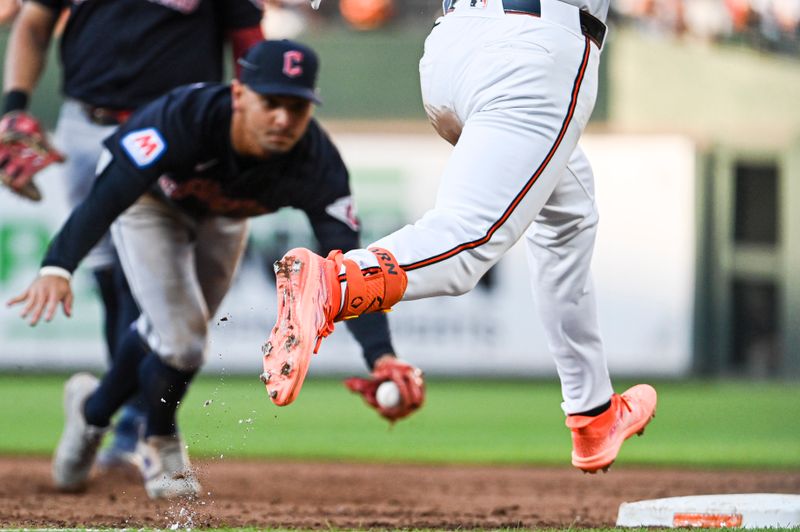 Jun 24, 2024; Baltimore, Maryland, USA;  Baltimore Orioles first baseman Ryan O'Hearn (32) beats a diving Cleveland Guardians second baseman Andrés Giménez (0) to first base for a third inning single at Oriole Park at Camden Yards. Mandatory Credit: Tommy Gilligan-USA TODAY Sports