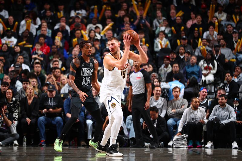 BROOKLYN, NY - OCTOBER 29: Nikola Jokic #15 of the Denver Nuggets handles the ball during the game against the Brooklyn Nets on October 29, 2024 at Barclays Center in Brooklyn, New York. NOTE TO USER: User expressly acknowledges and agrees that, by downloading and or using this Photograph, user is consenting to the terms and conditions of the Getty Images License Agreement. Mandatory Copyright Notice: Copyright 2024 NBAE (Photo by David L. Nemec/NBAE via Getty Images)