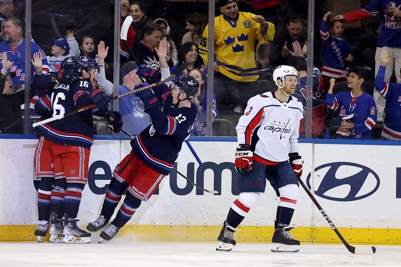 Jan 14, 2024; New York, New York, USA; New York Rangers left wing Artemi Panarin (10) celebrates his goal with center Vincent Trocheck (16) and. left wing Alexis Lafreniere (13) in front of Washington Capitals defenseman Nick Jensen (3) during the first period at Madison Square Garden. Mandatory Credit: Brad Penner-USA TODAY Sports