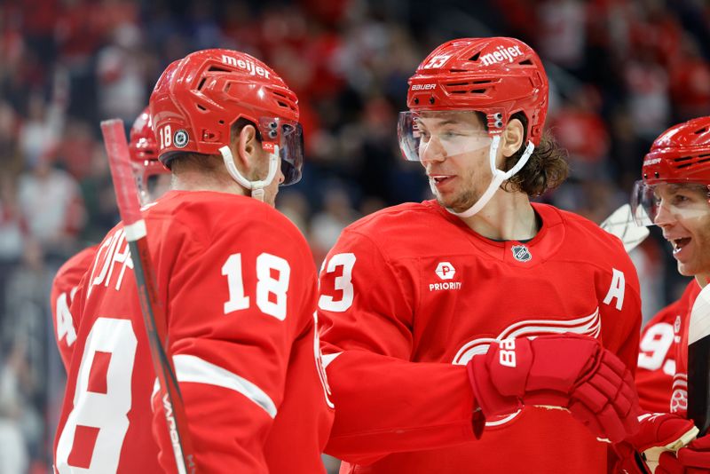 Dec 14, 2024; Detroit, Michigan, USA;  Detroit Red Wings defenseman Moritz Seider (53) receives congratulations from center Andrew Copp (18) after scoring in the second period against the Toronto Maple Leafs at Little Caesars Arena. Mandatory Credit: Rick Osentoski-Imagn Images