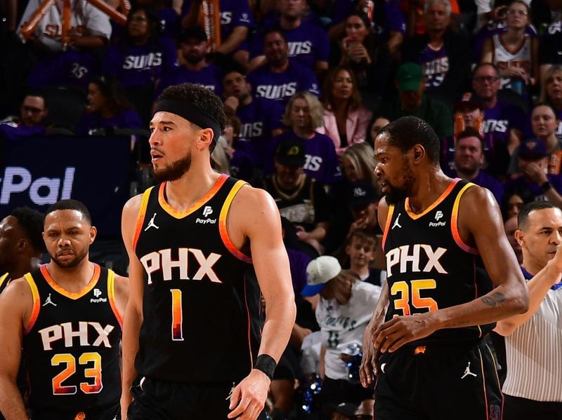 PHOENIX, AZ - APRIL  28: Devin Booker #1 of the Phoenix Suns and Kevin Durant #35 look on during the game against the Minnesota Timberwolves during Round 1 Game 4 of the 2024 NBA Playoffs on April 28, 2024 at Footprint Center in Phoenix, Arizona. NOTE TO USER: User expressly acknowledges and agrees that, by downloading and or using this photograph, user is consenting to the terms and conditions of the Getty Images License Agreement. Mandatory Copyright Notice: Copyright 2024 NBAE (Photo by Kate Frese/NBAE via Getty Images)