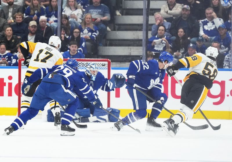 Oct 12, 2024; Toronto, Ontario, CAN; Pittsburgh Penguins defenseman Kris Letang (58) scores a goal against the Toronto Maple Leafs during the first period at Scotiabank Arena. Mandatory Credit: Nick Turchiaro-Imagn Images