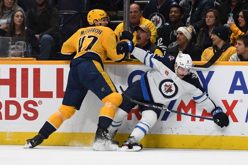 Nov 26, 2023; Nashville, Tennessee, USA; Nashville Predators right wing Michael McCarron (47) hits Winnipeg Jets defenseman Dylan DeMelo (2) during the first period at Bridgestone Arena. Mandatory Credit: Christopher Hanewinckel-USA TODAY Sports