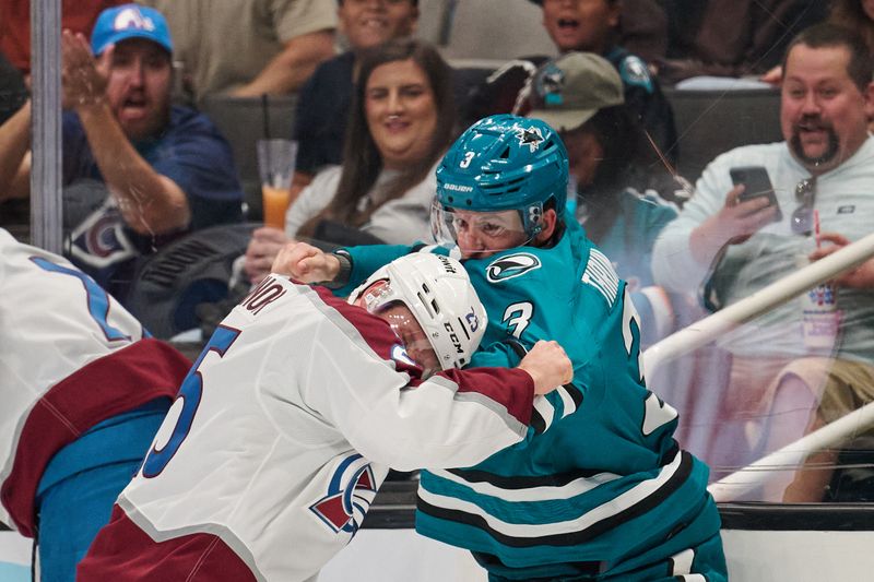 Oct 20, 2024; San Jose, California, USA; San Jose Sharks defenseman Henry Thrun (3) fights against Colorado Avalanche right wing Logan O'Connor (25) during the second period at SAP Center at San Jose. Mandatory Credit: Robert Edwards-Imagn Images