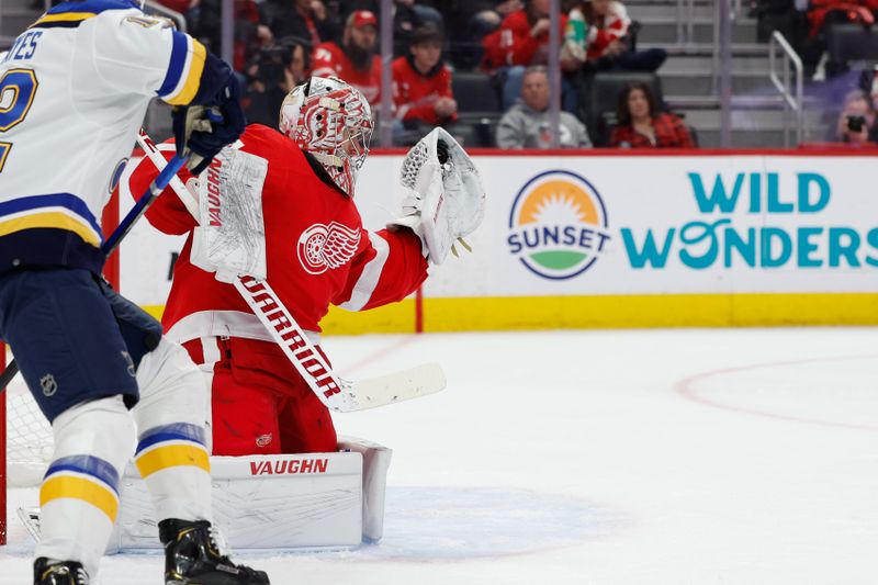 Feb 24, 2024; Detroit, Michigan, USA;  Detroit Red Wings goaltender Alex Lyon (34) makes a save in front of St. Louis Blues right wing Kevin Hayes (12) in the first period at Little Caesars Arena. Mandatory Credit: Rick Osentoski-USA TODAY Sports