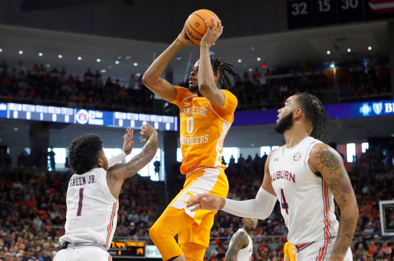 Mar 4, 2023; Auburn, Alabama, USA;  Tennessee Volunteers forward Jonas Aidoo (0) shoots the ball against Auburn Tigers guard Wendell Green Jr. (1) during the first half at Neville Arena. Mandatory Credit: John Reed-USA TODAY Sports