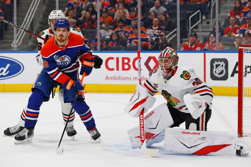 Nov 1, 2025; Edmonton, Alberta, CAN; Edmonton Oilers forward Jack Roslovic (28) looks for a pass in front of Chicago Blackhawks goaltender Spencer Knight (30) during the first period at Rogers Place. Mandatory Credit: Perry Nelson-Imagn Images