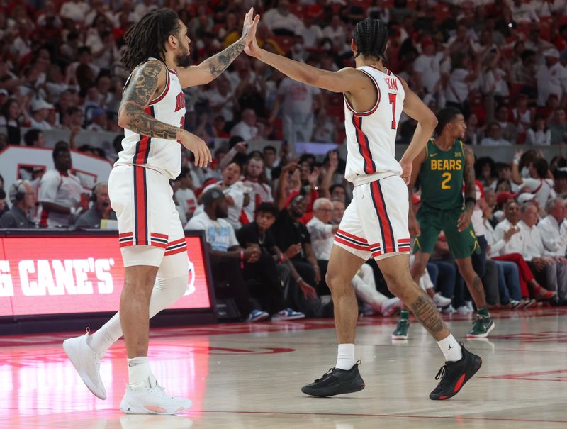 Feb 10, 2025; Houston, Texas, USA;  Houston Cougars guard Milos Uzan (7) celebrates  guard Emanuel Sharp (21) three point basket against the Baylor Bears in the second half at Fertitta Center. Mandatory Credit: Thomas Shea-Imagn Images