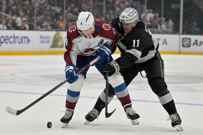 Oct 7, 2025; Los Angeles, California, USA;  Colorado Avalanche defenseman Cale Makar (8) and Los Angeles Kings center Anze Kopitar (11) battle for the puck during the first period at Crypto.com Arena. Mandatory Credit: Jayne Kamin-Oncea-Imagn Images