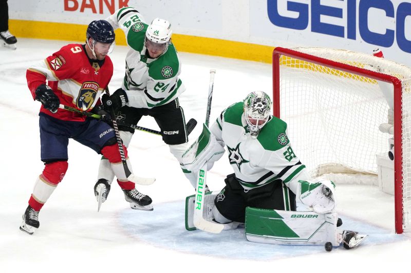 Dec 6, 2023; Sunrise, Florida, USA; Dallas Stars goaltender Jake Oettinger (29) makes a save as center Roope Hintz (24) and Florida Panthers center Sam Bennett (9) battle for position during the second period at Amerant Bank Arena. Mandatory Credit: Jim Rassol-USA TODAY Sports