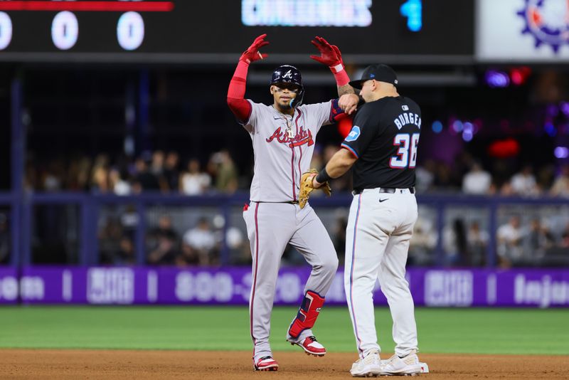 Apr 12, 2024; Miami, Florida, USA; Atlanta Braves shortstop Orlando Arcia (11) reacts from second base after hitting a double against the Miami Marlins during the seventh inning at loanDepot Park. Mandatory Credit: Sam Navarro-USA TODAY Sports