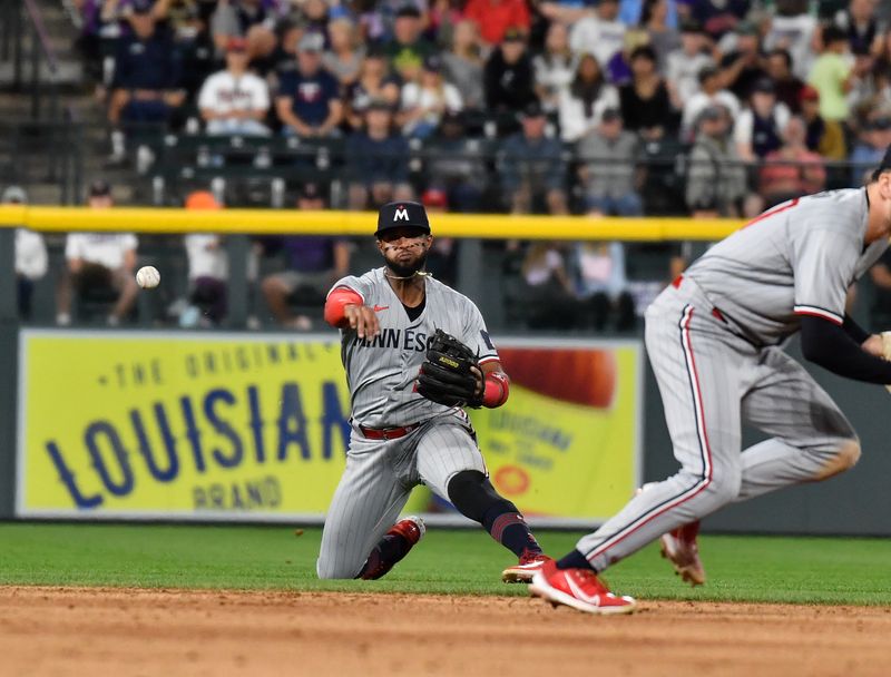 Sep 30, 2023; Denver, Colorado, USA; Minnesota Twins shortstop Willi Castro (50) throws out Colorado Rockies second baseman Brendan Rodgers at first base for the out in the third inning at Coors Field. Mandatory Credit: John Leyba-USA TODAY Sports