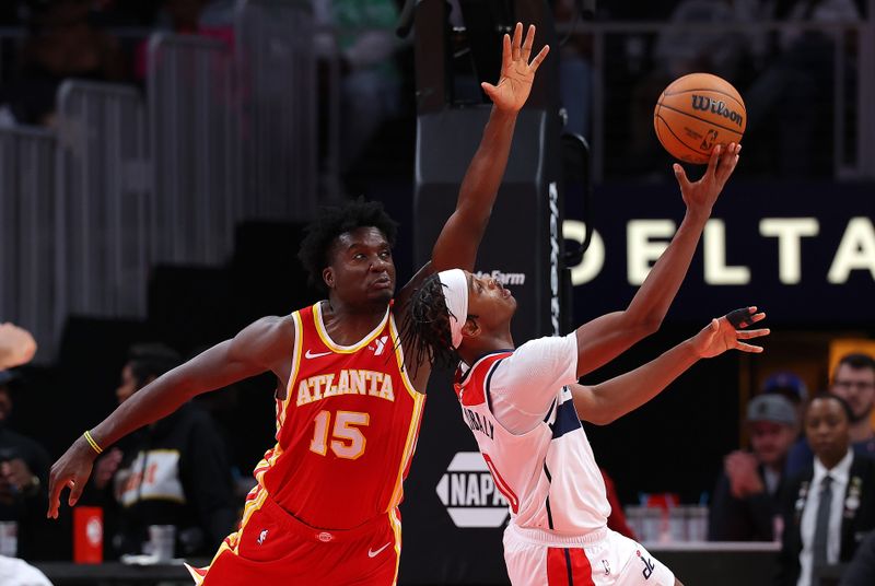 ATLANTA, GEORGIA - OCTOBER 28:  Bilal Coulibaly #0 of the Washington Wizards draws a foul from Clint Capela #15 of the Atlanta Hawks during the fourth quarter at State Farm Arena on October 28, 2024 in Atlanta, Georgia.  NOTE TO USER: User expressly acknowledges and agrees that, by downloading and/or using this photograph, user is consenting to the terms and conditions of the Getty Images License Agreement.  (Photo by Kevin C. Cox/Getty Images)