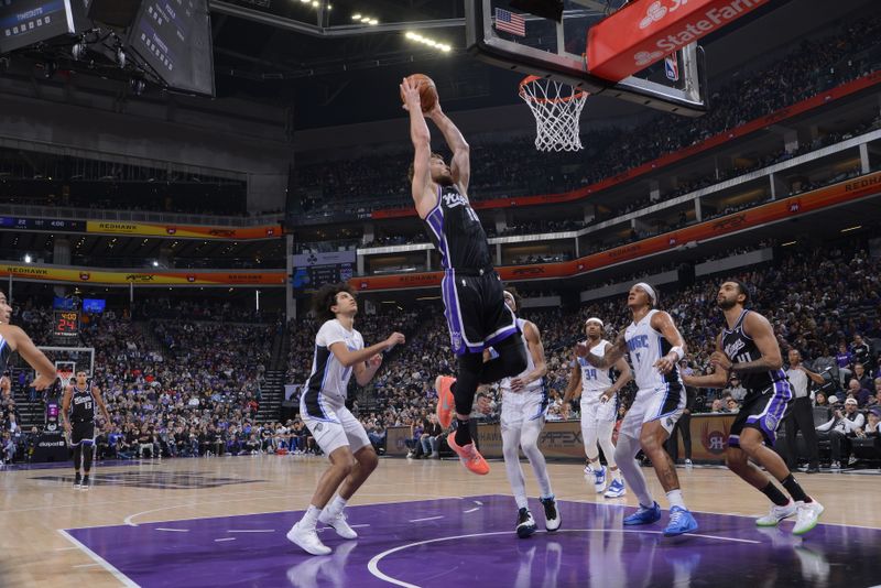 SACRAMENTO, CA - JANUARY 3: Domantas Sabonis #10 of the Sacramento Kings drives to the basket during the game against the Orlando Magic on January 3, 2024 at Golden 1 Center in Sacramento, California. NOTE TO USER: User expressly acknowledges and agrees that, by downloading and or using this Photograph, user is consenting to the terms and conditions of the Getty Images License Agreement. Mandatory Copyright Notice: Copyright 2024 NBAE (Photo by Rocky Widner/NBAE via Getty Images)